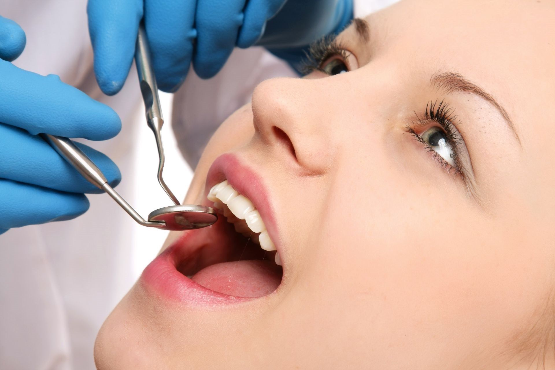 Dentist examining teeth of woman