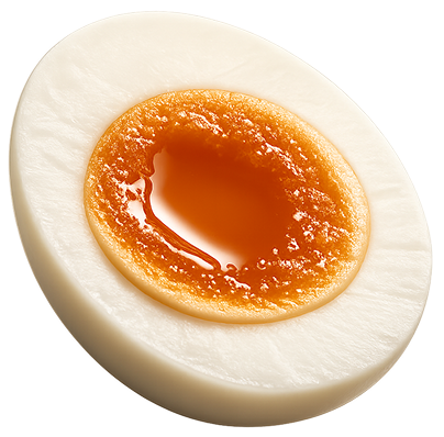 A soft-boiled egg cut in half, showing firm white and a bright orange, jammy yolk center on a plain white background.