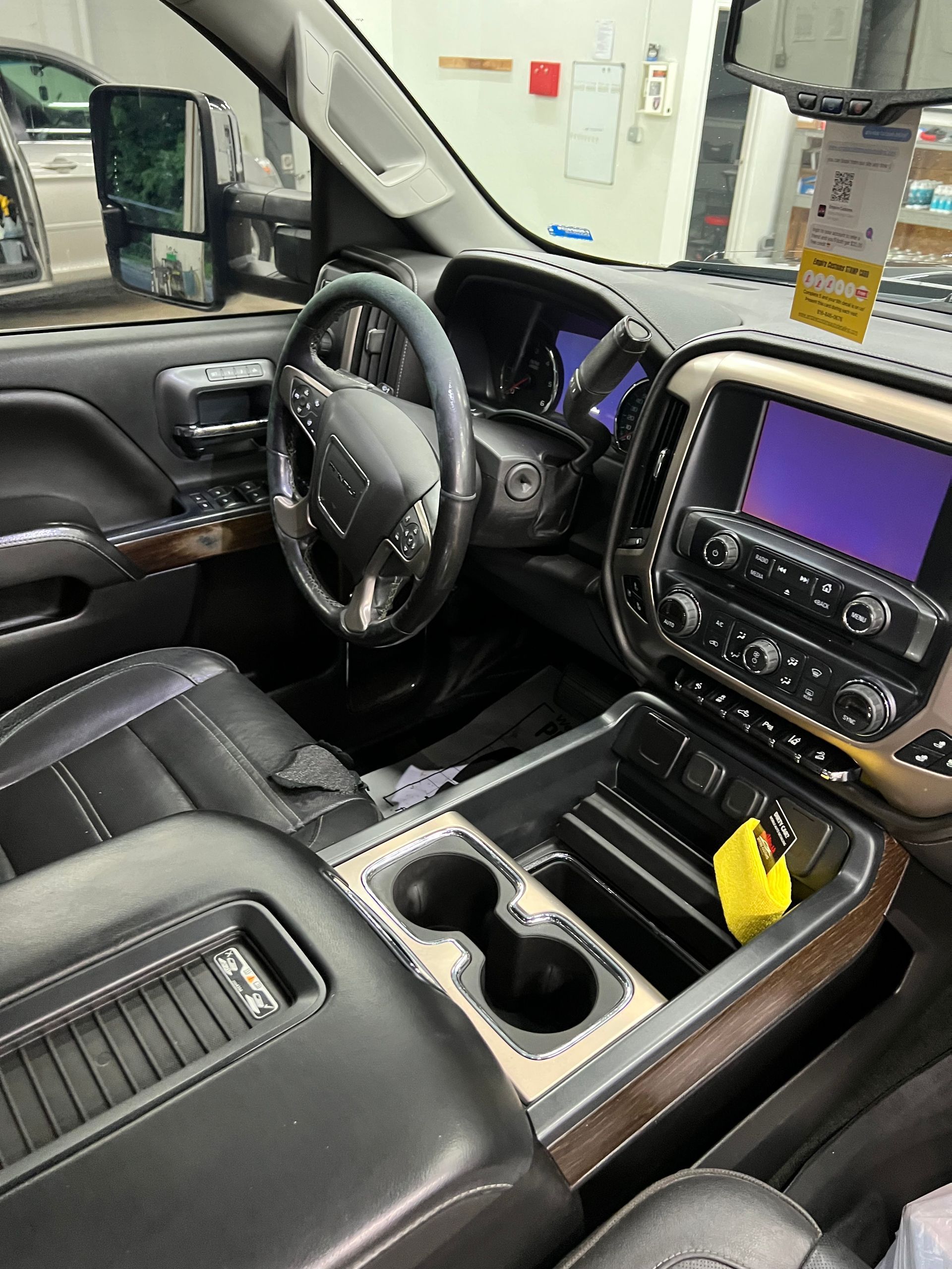 The interior of a pickup truck with a steering wheel and a dashboard.