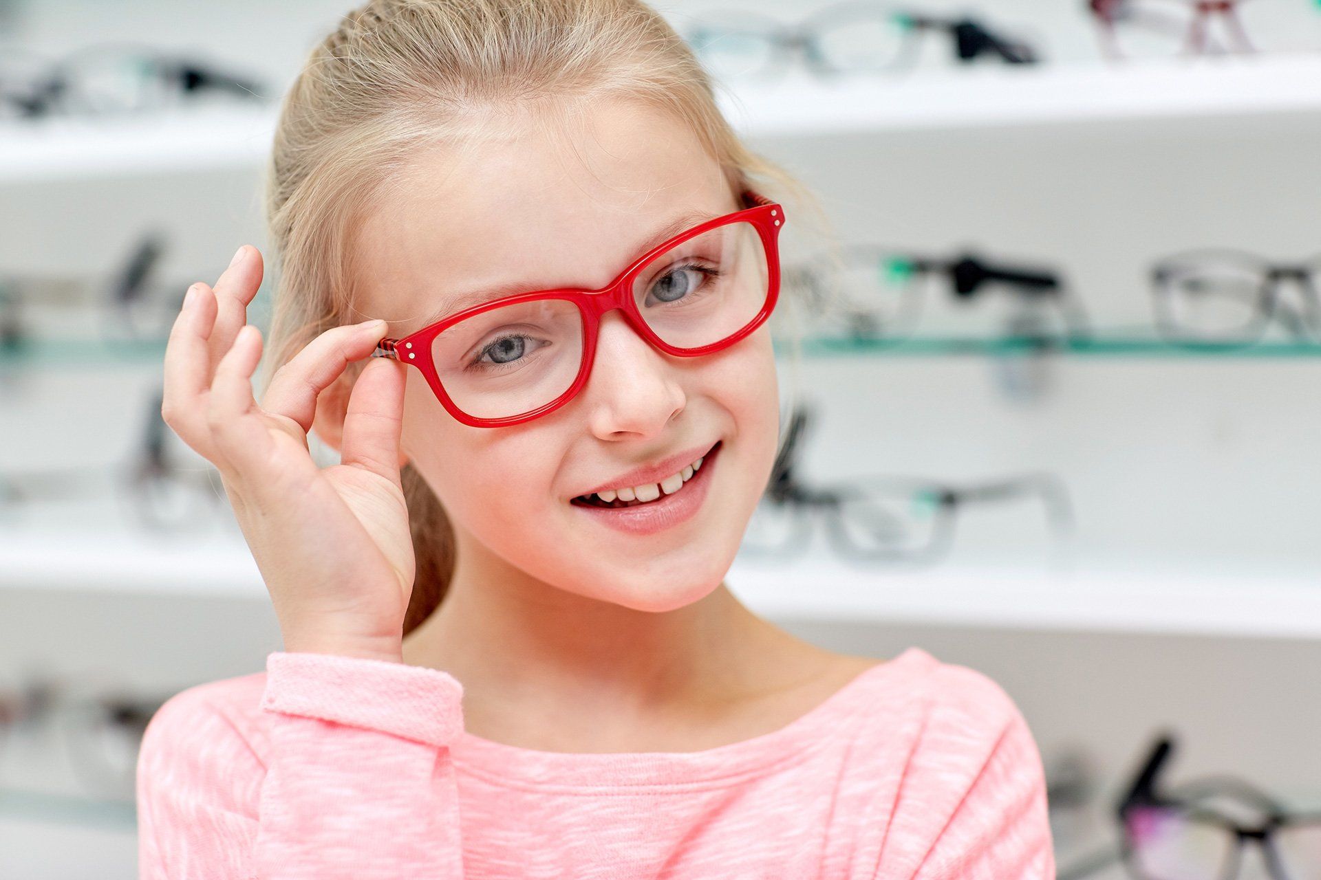 young girl with new red frame glasses