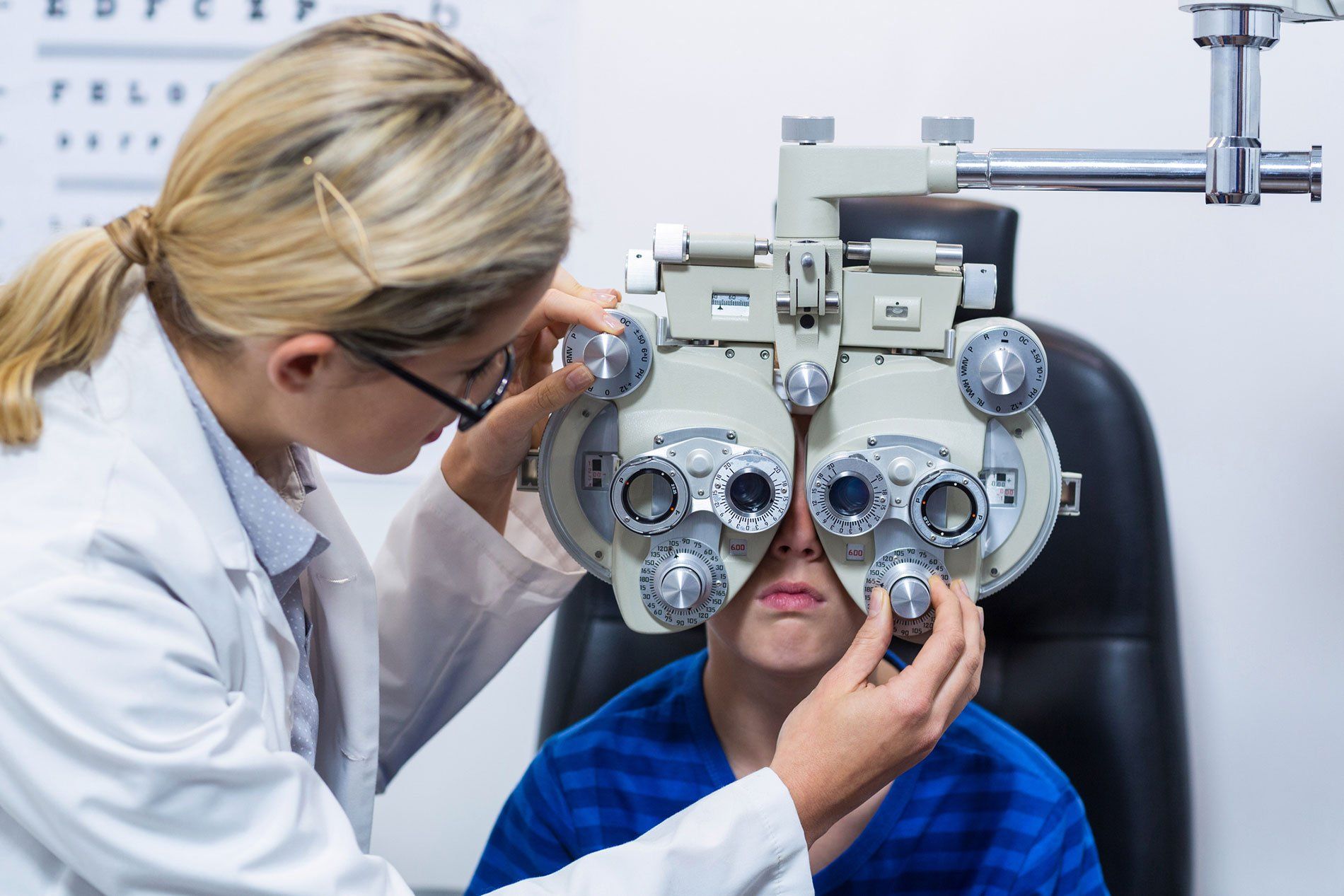 Children's Optometrist Performing Eye Exam