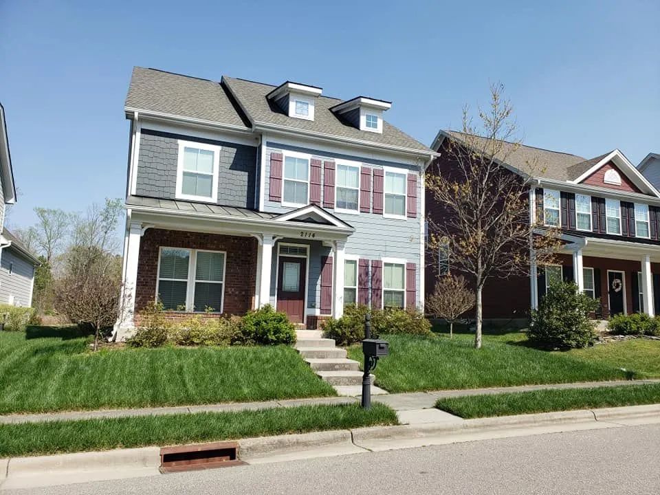 A large house with a lush green lawn in front of it.