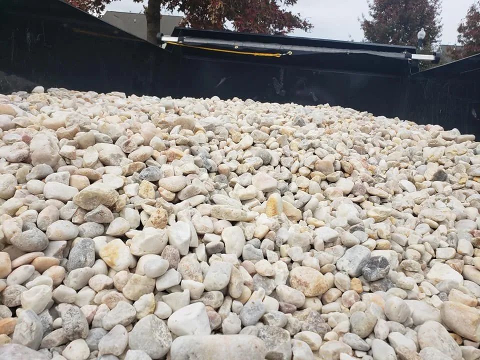 A pile of rocks is sitting on top of a pile of gravel.