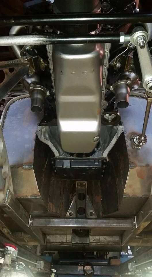 A close up of the underside of a car engine.