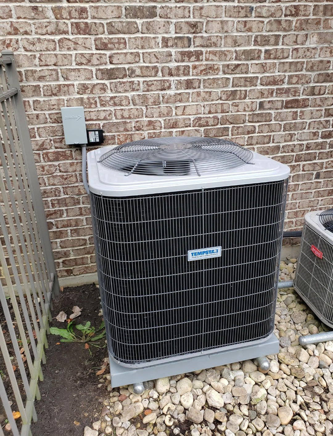 Furnace and air conditioner unit in a basement setting, with ductwork and a cooler nearby.