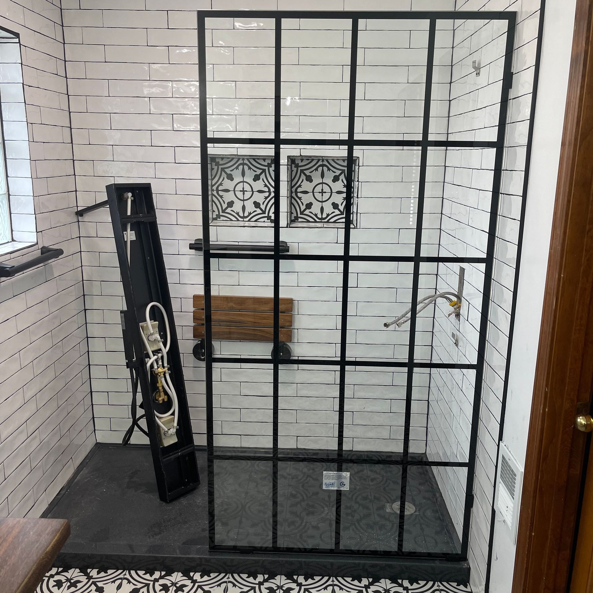 A bathroom sink with a faucet and shelves on the wall.