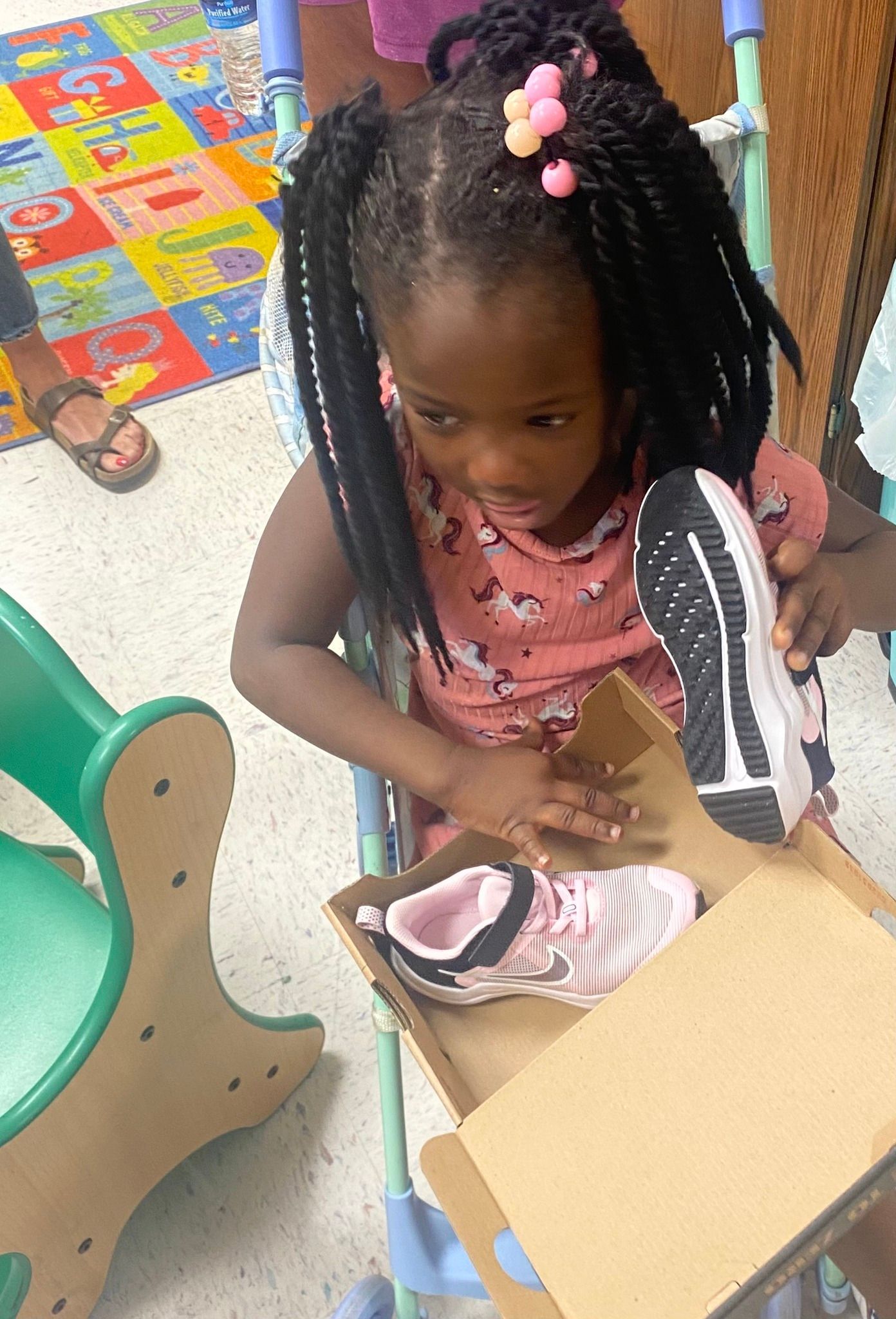 Girl Holding Her New Shoes | Bridgeton, MO | Room at the Inn