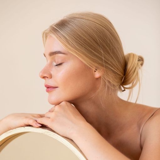A woman is leaning on a chair with her eyes closed