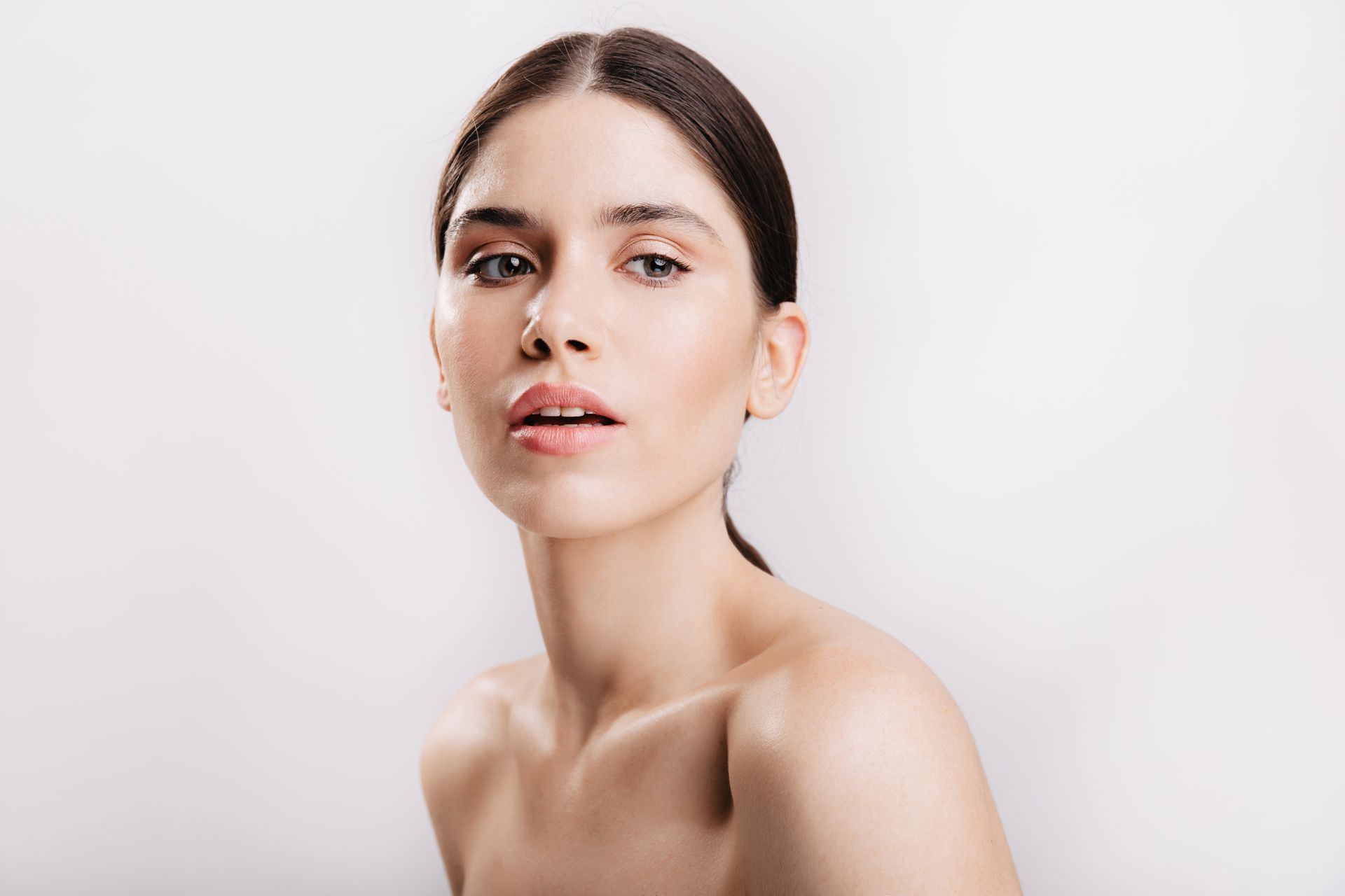 A close up of a woman 's face with a white background.