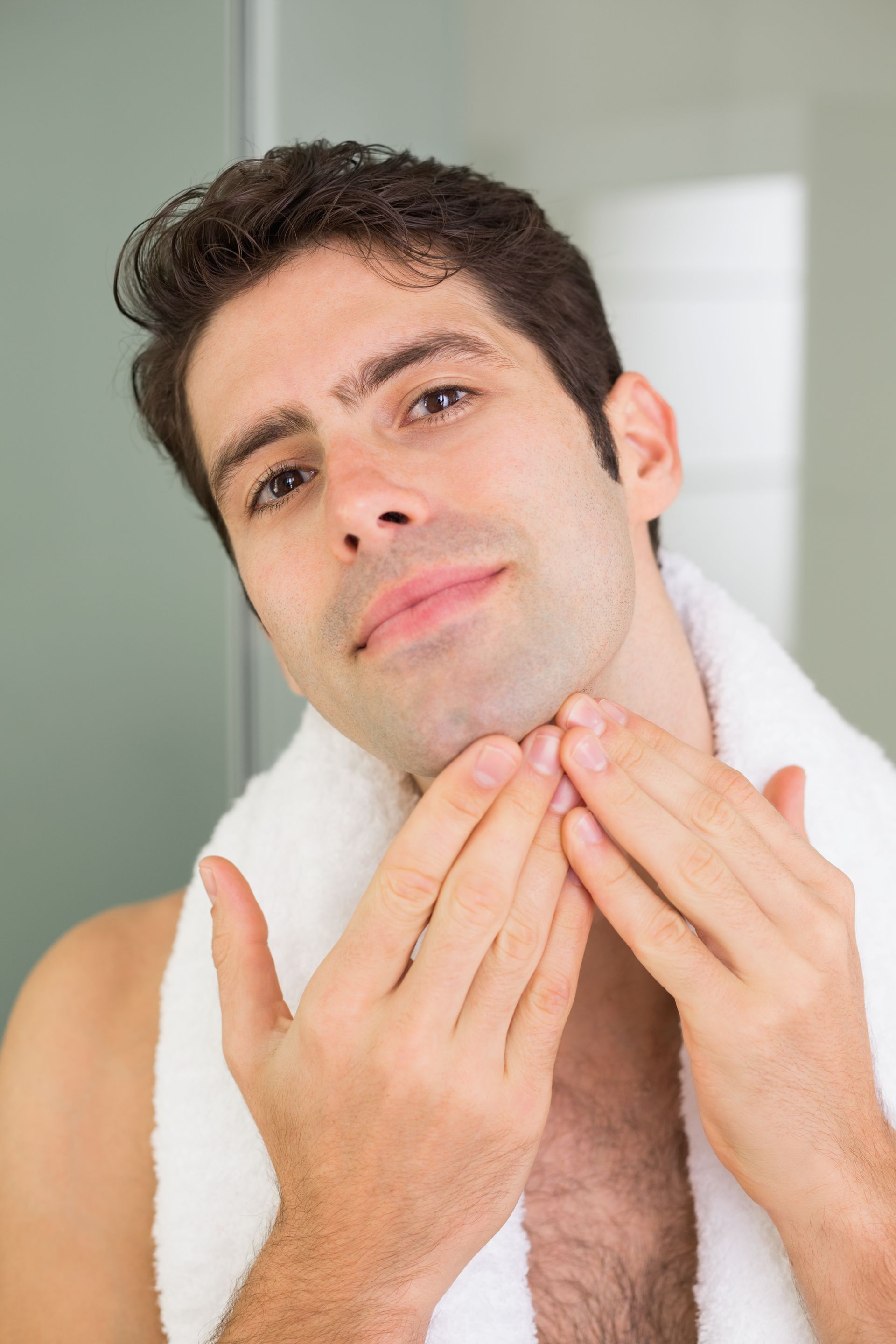 A close up of a woman 's face with her hands on it.