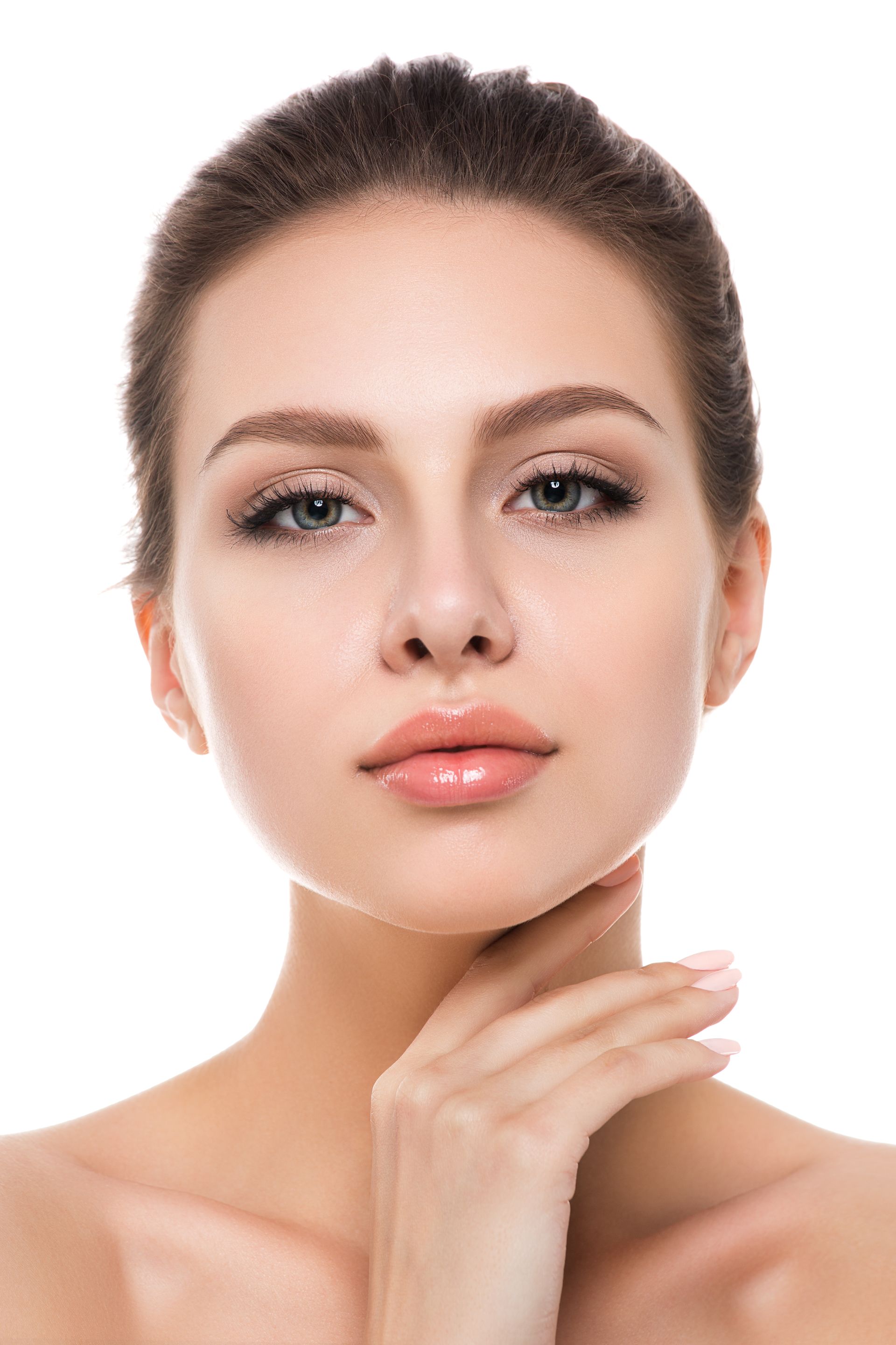 A close up of a woman 's face with her hand on her chin.