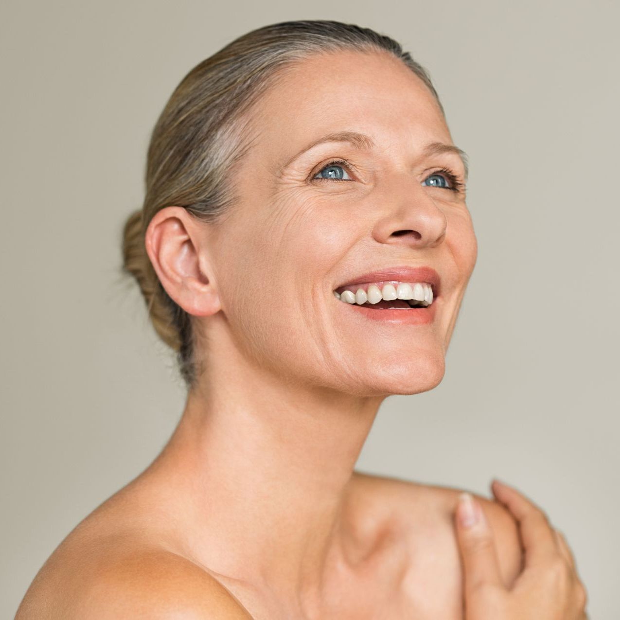 A woman is getting a laser treatment on her face.