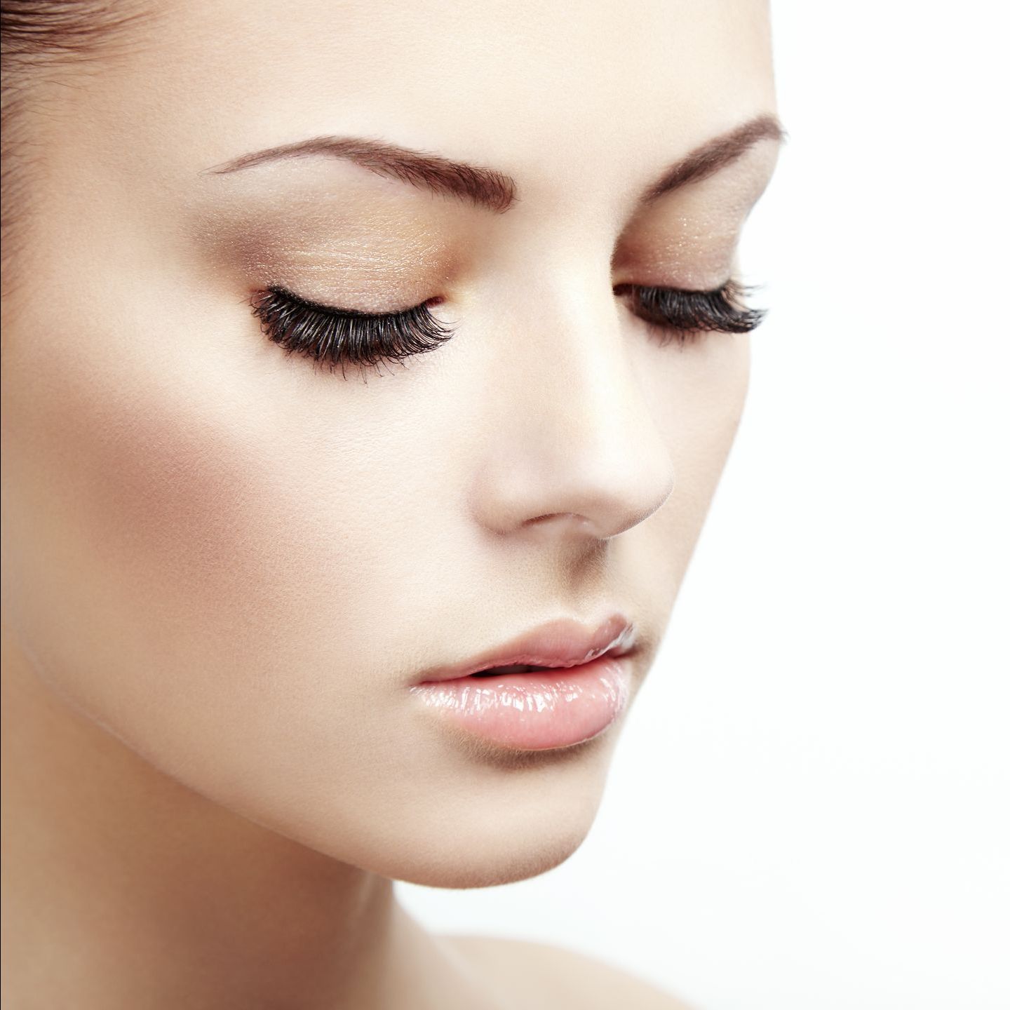 A close up of a woman 's face with her eyes closed.