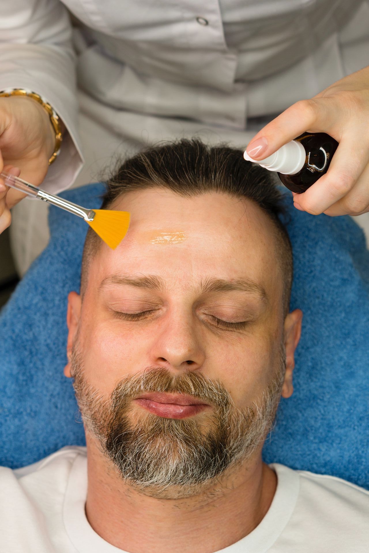 A woman is getting a facial treatment at a spa.