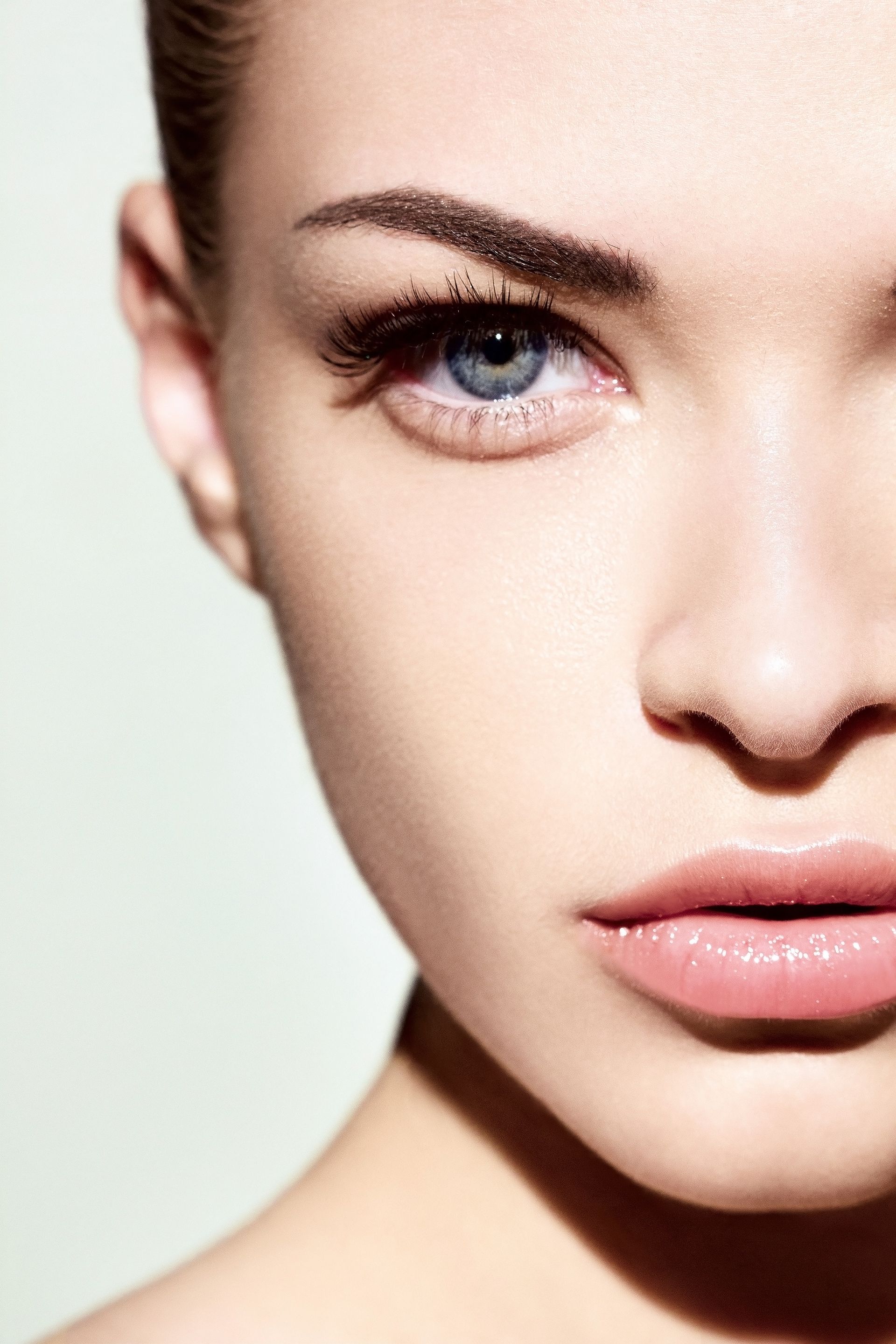 A close up of a woman 's face with her eyes closed