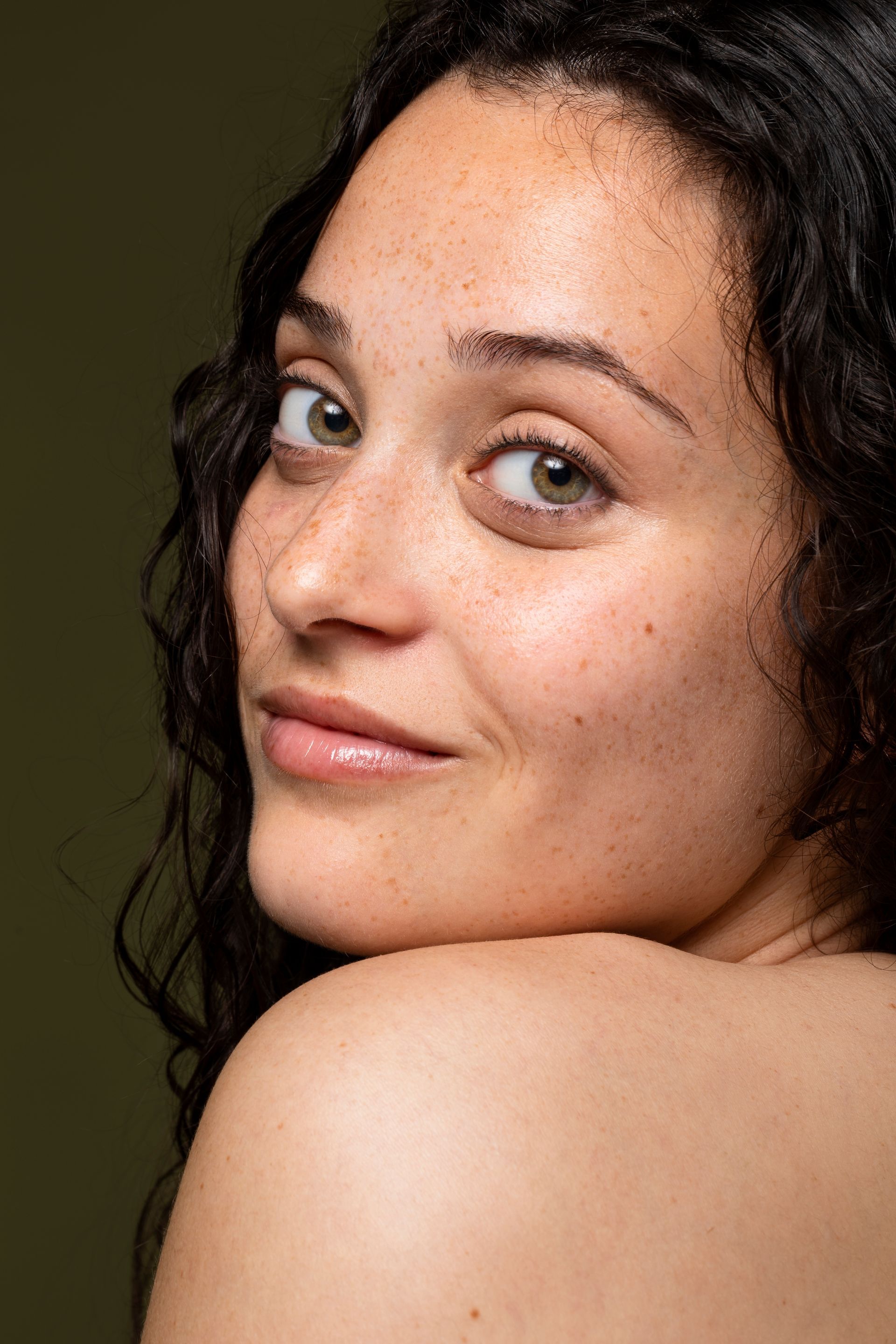 A before and after photo of a woman 's face with and without makeup.