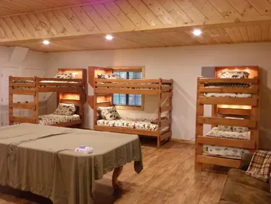 A room with bunk beds and a pool table