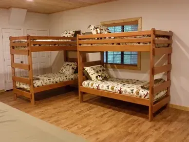 Three bunk beds are sitting next to each other in a room.