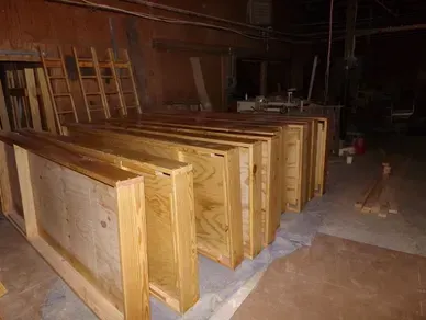 A warehouse filled with lots of wooden boxes and ladders.