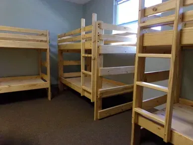 A room filled with bunk beds and a window.