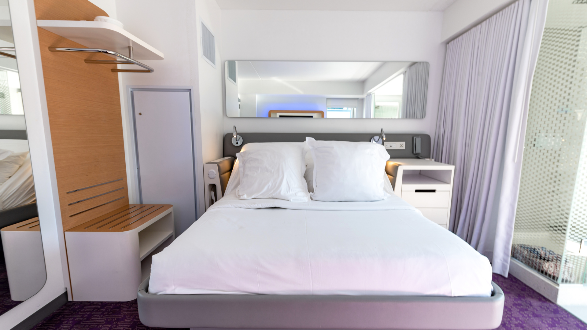 A bunk bed with stairs leading up to it in a wooden room.