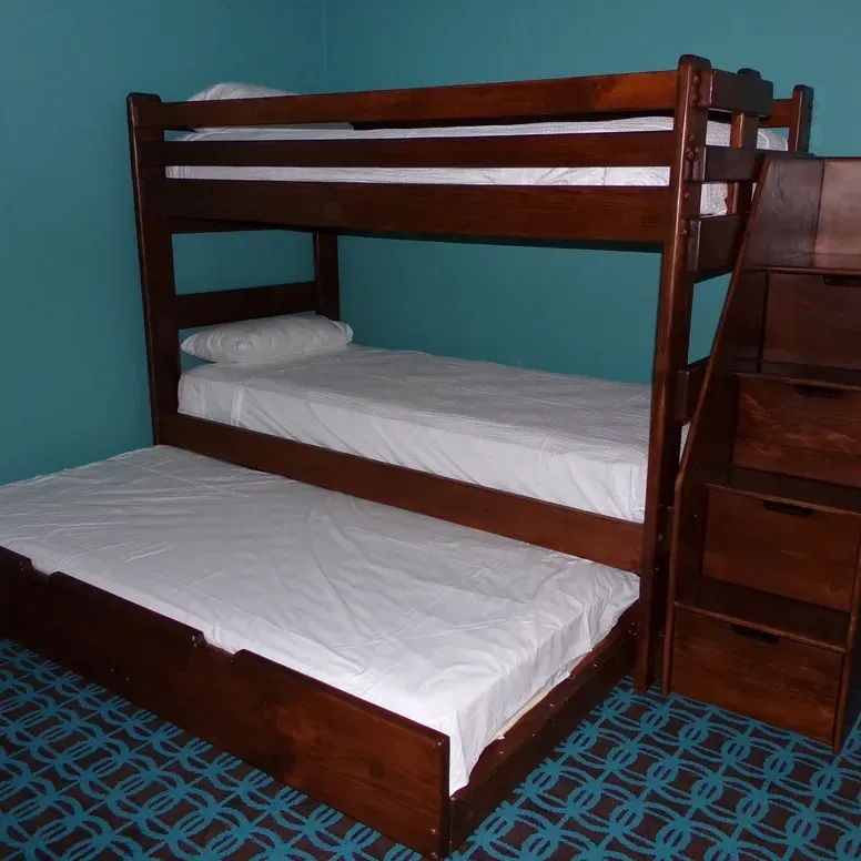 A bunk bed with stairs leading up to it