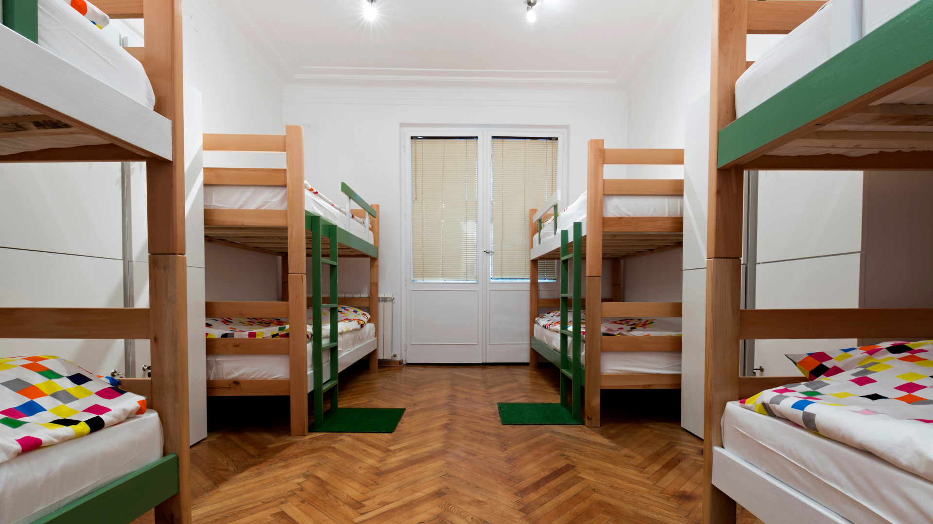 A bunk bed with stairs leading up to it in a wooden room.