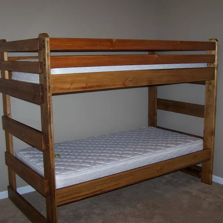 A wooden bunk bed with a white mattress
