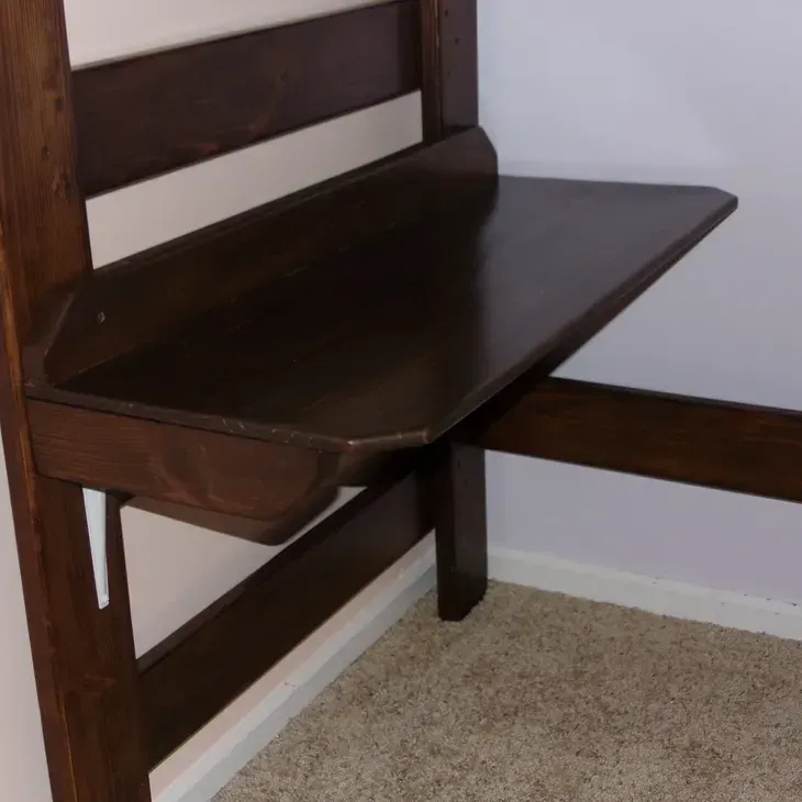 A wooden bench with a shelf attached to it