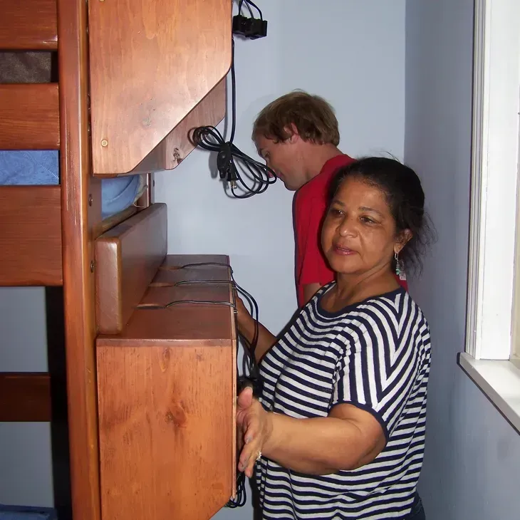 A woman in a striped shirt is standing next to a man in a red shirt
