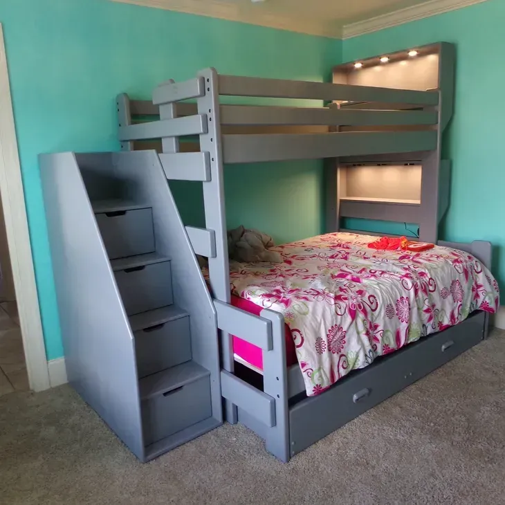 A bunk bed with stairs leading up to it