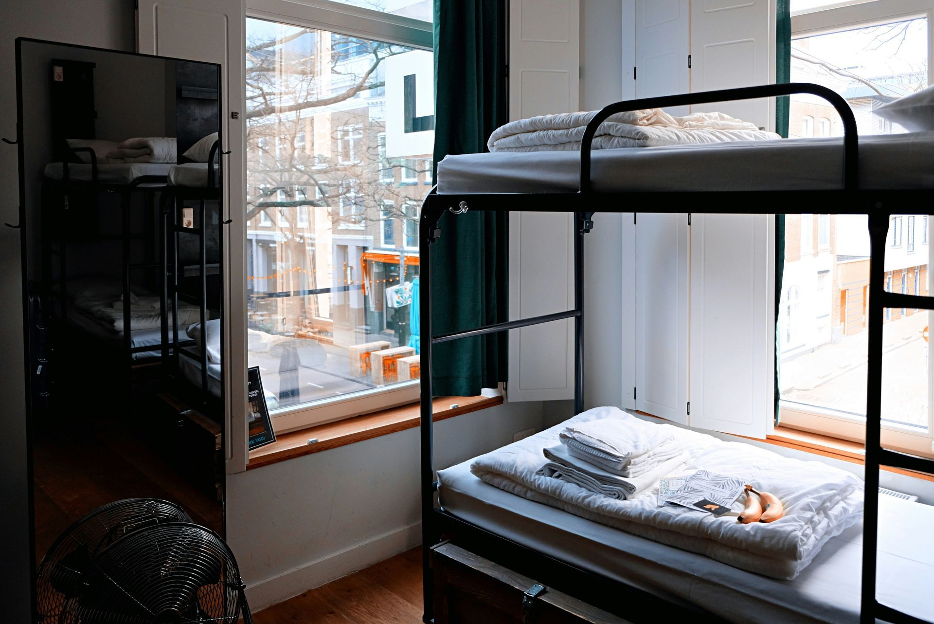A bunk bed with stairs leading up to it in a wooden room.