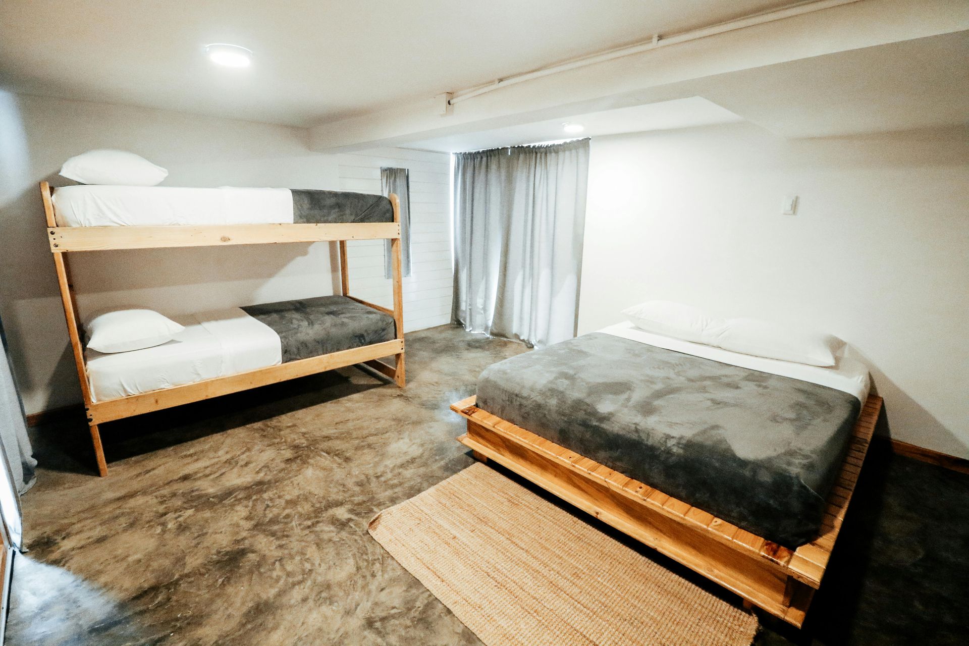 A bunk bed with stairs leading up to it in a wooden room.