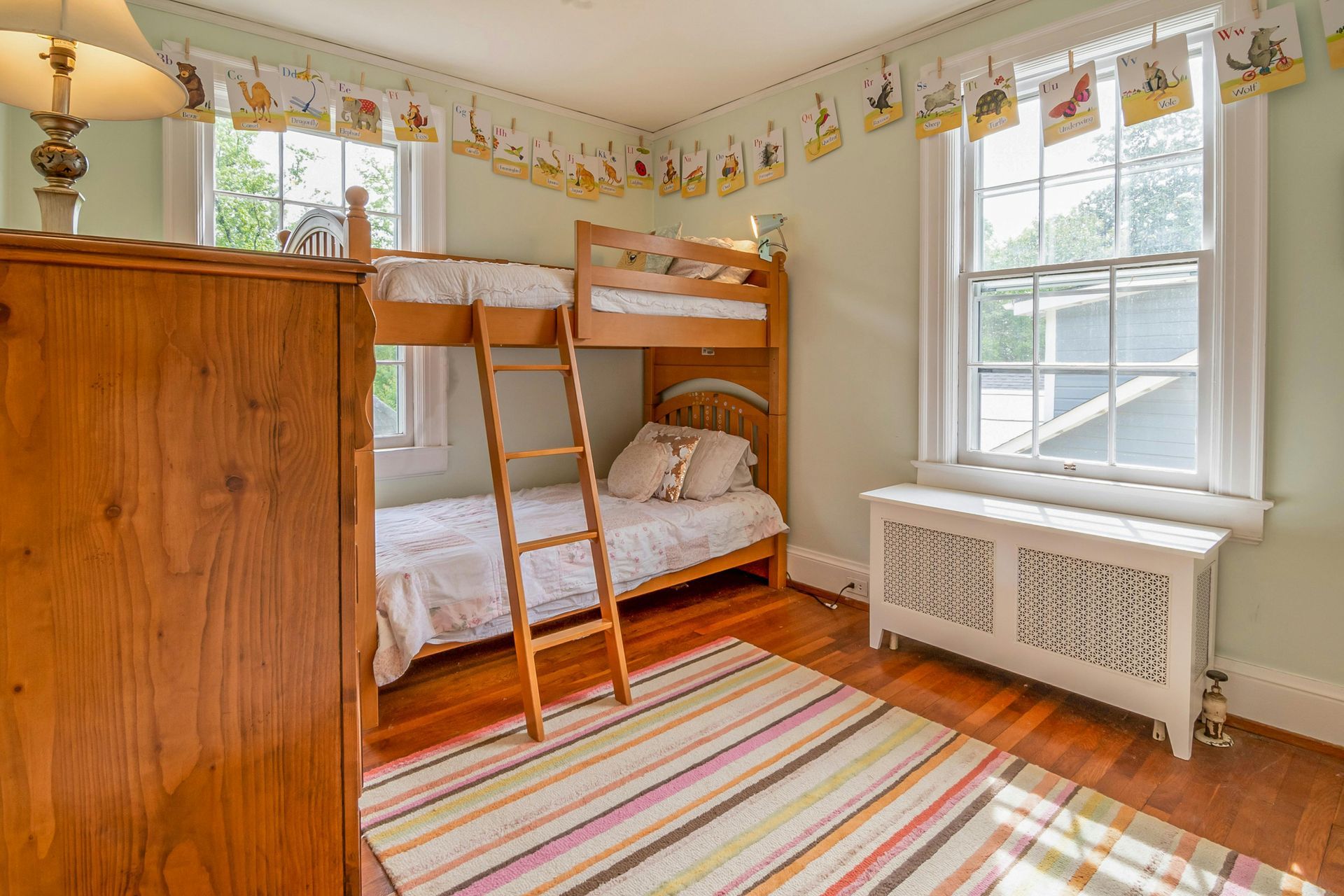 A bunk bed with stairs leading up to it in a wooden room.