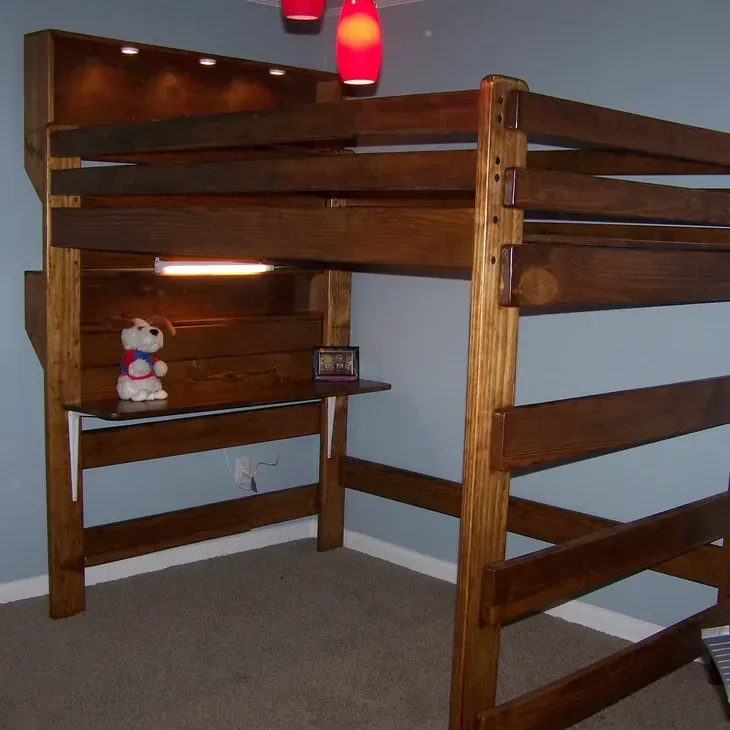 A bunk bed with a desk underneath it