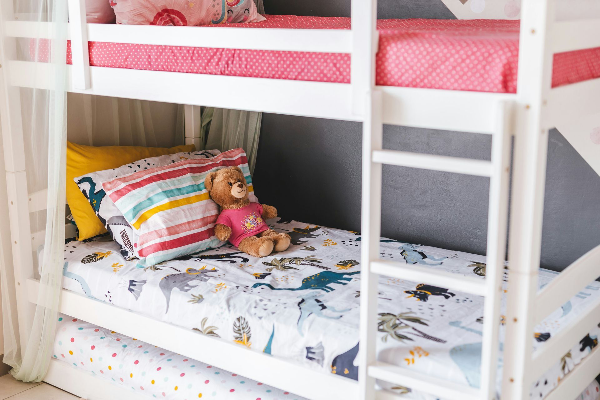 A bunk bed with stairs leading up to it in a wooden room.