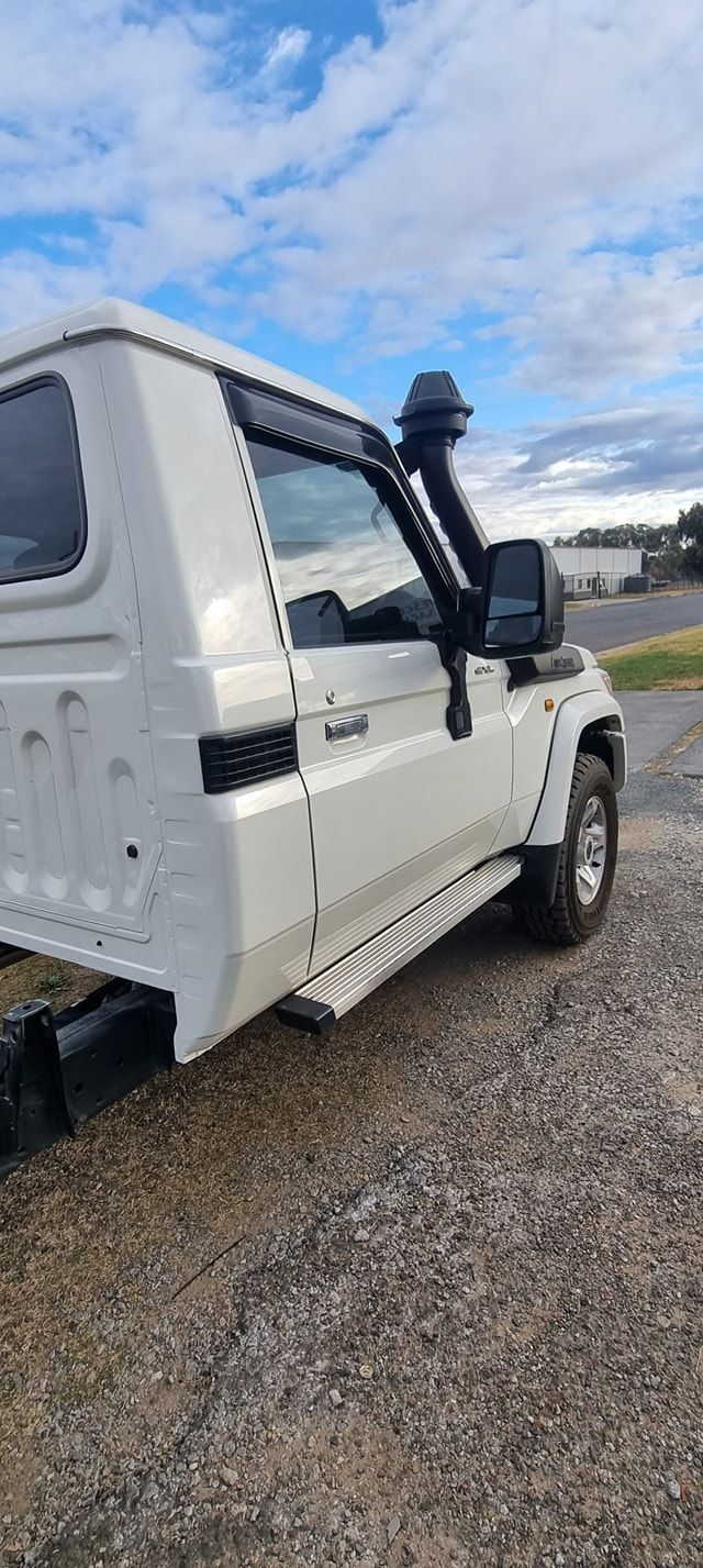 White Toyota Land Cruiser with Snorkel and Running Boards Parked on Gravel — Sparky's 4x4 Auto Electrical In Armidale, NSW