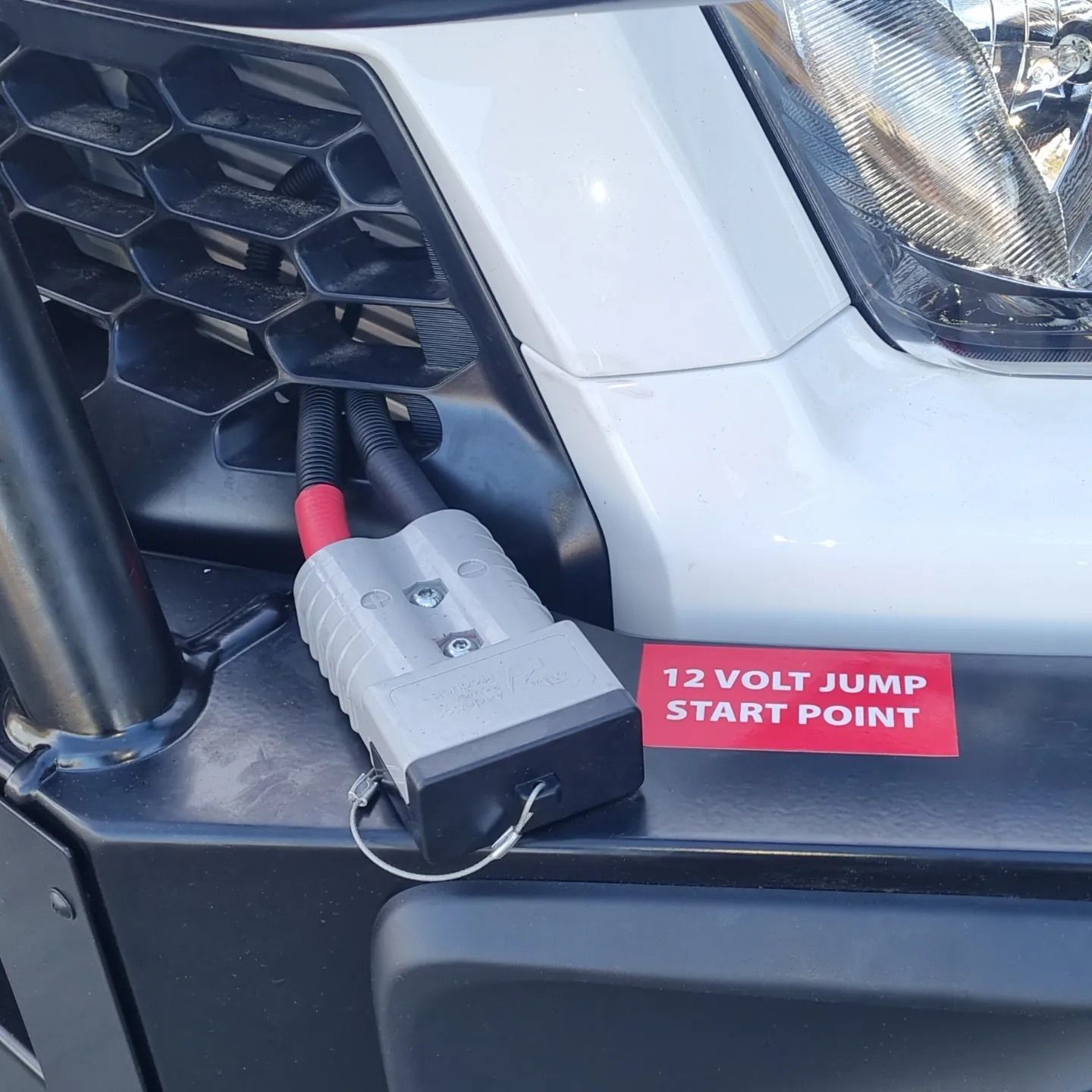 Close-Up of A White Truck Bumper with A 12-Volt Jump-Start Point Connector — Sparky's 4x4 Auto Electrical In Taminda, NSW