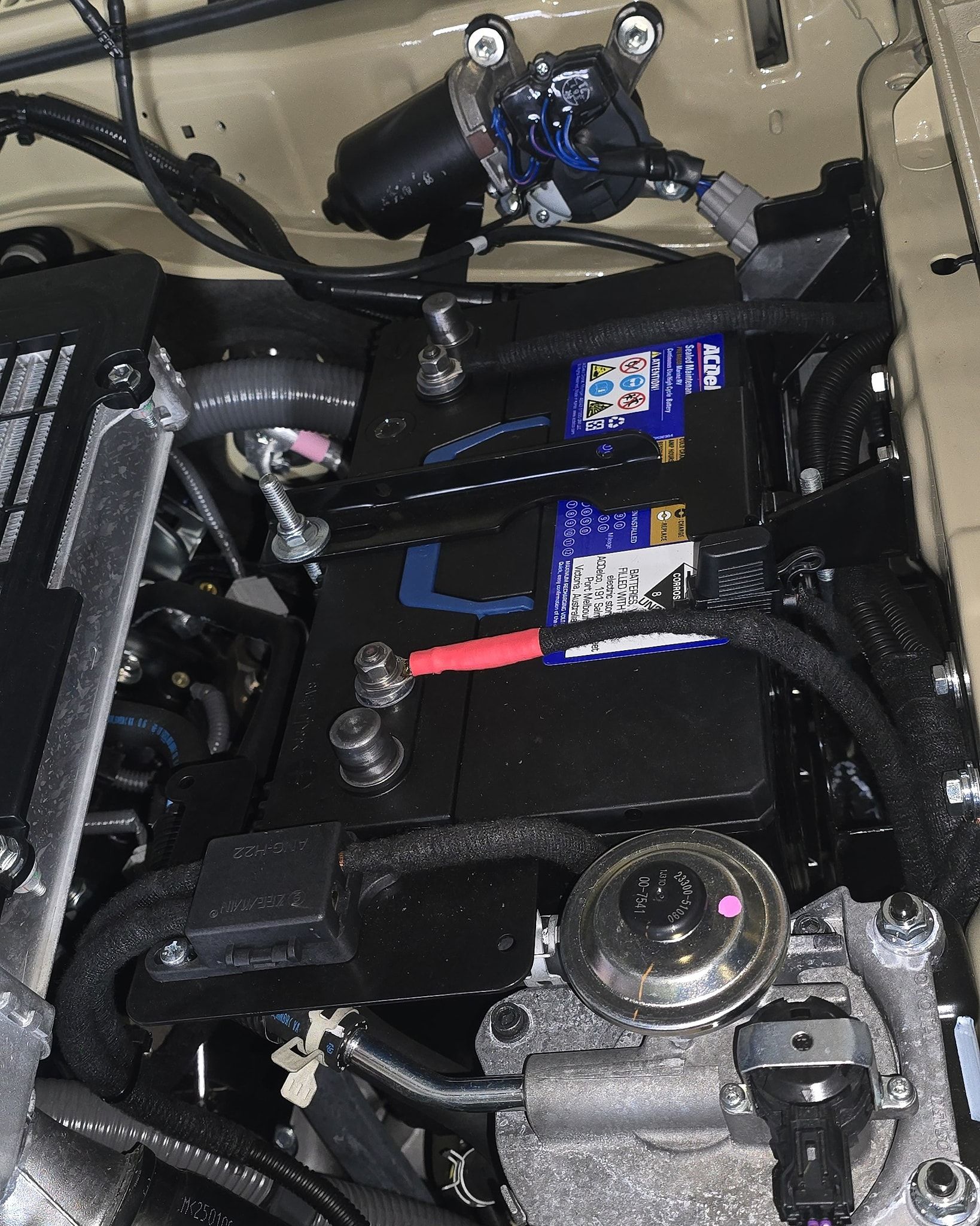 Car Battery in A Black Compartment, with Red and Black Terminals — Sparky's 4x4 Auto Electrical In Taminda, NSW
