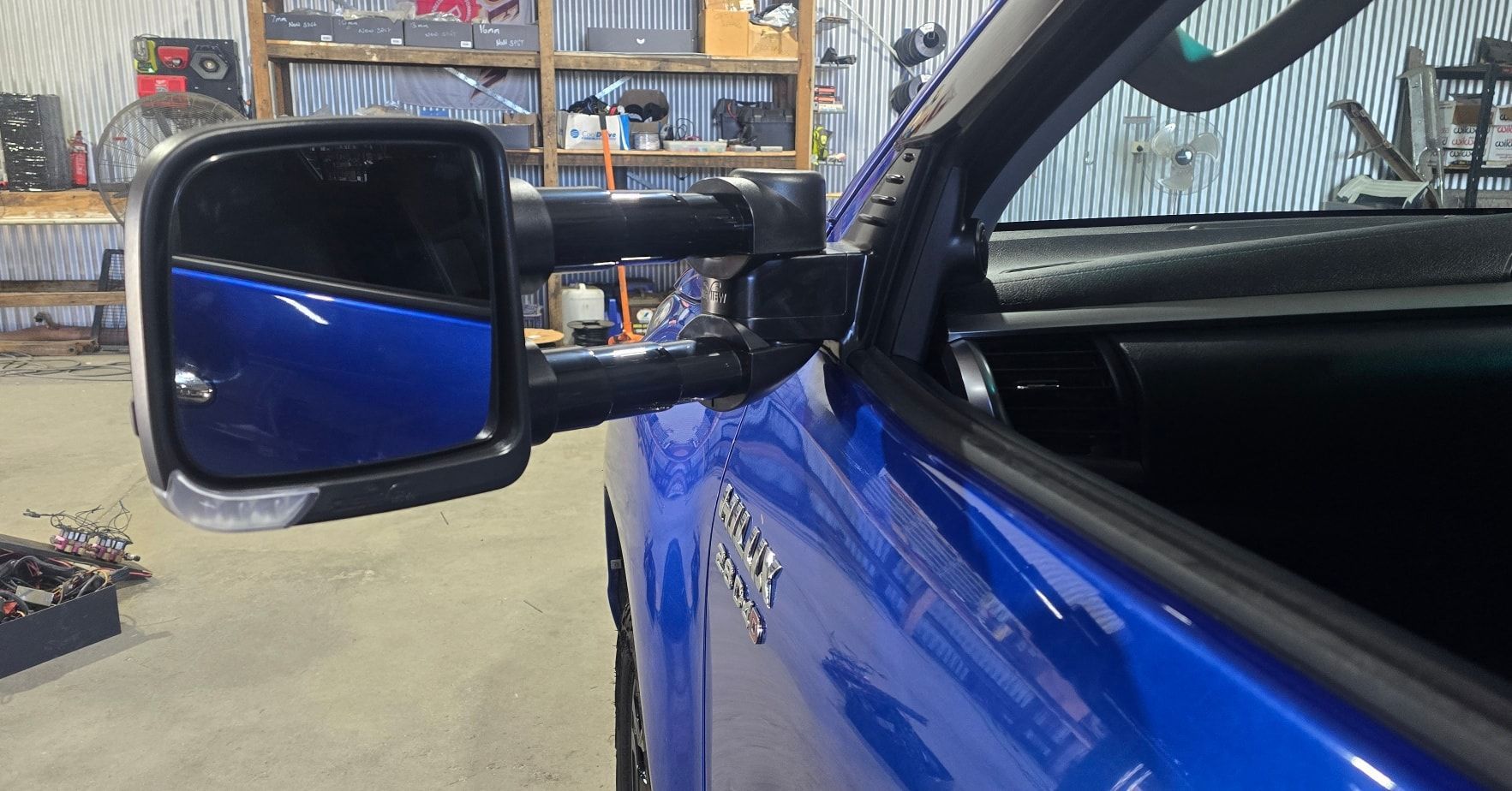 Blue Truck's Side Mirror Extended Outward in A Garage — Sparky's 4x4 Auto Electrical In Taminda, NSW