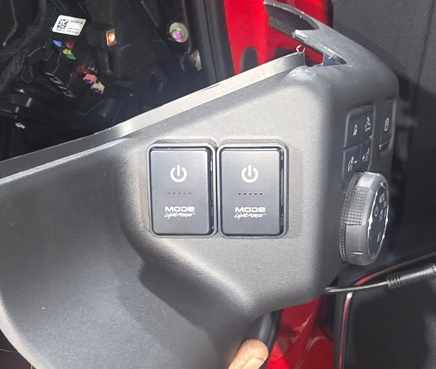 A Person is Holding a Pair of Switches That Say Mode on Them — Sparky's 4x4 Auto Electrical In Taminda, NSW