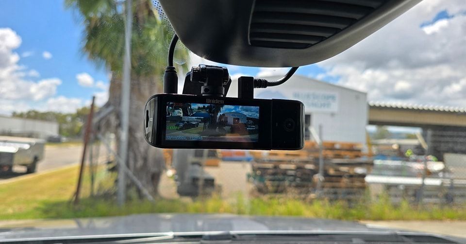 A Dash Cam is Hanging From the Rear View Mirror of a Car  — Sparky's 4x4 Auto Electrical In Taminda, NSW