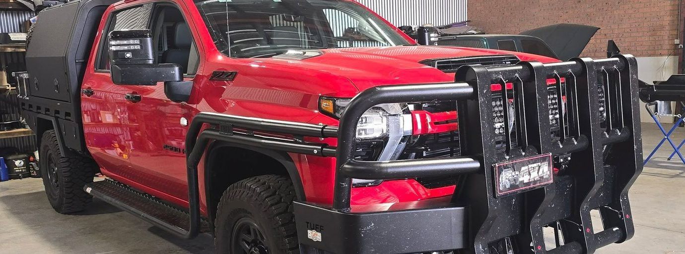 A Red Truck With a Black Bumper is Parked in a Garage — Sparky's 4x4 Auto Electrical In Taminda, NSW