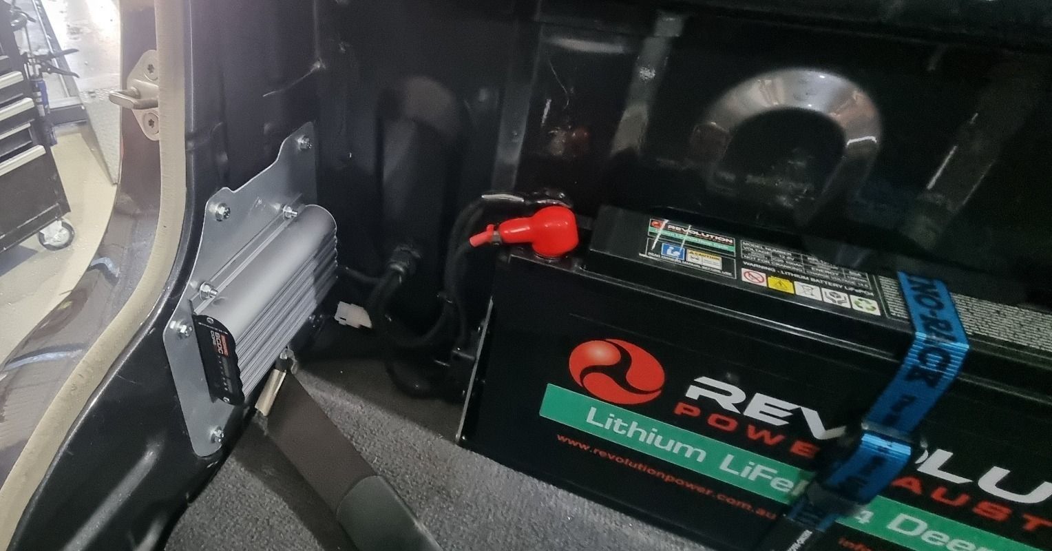 Two Batteries Are Sitting Under the Hood of a Car — Sparky's 4x4 Auto Electrical In Taminda, NSW