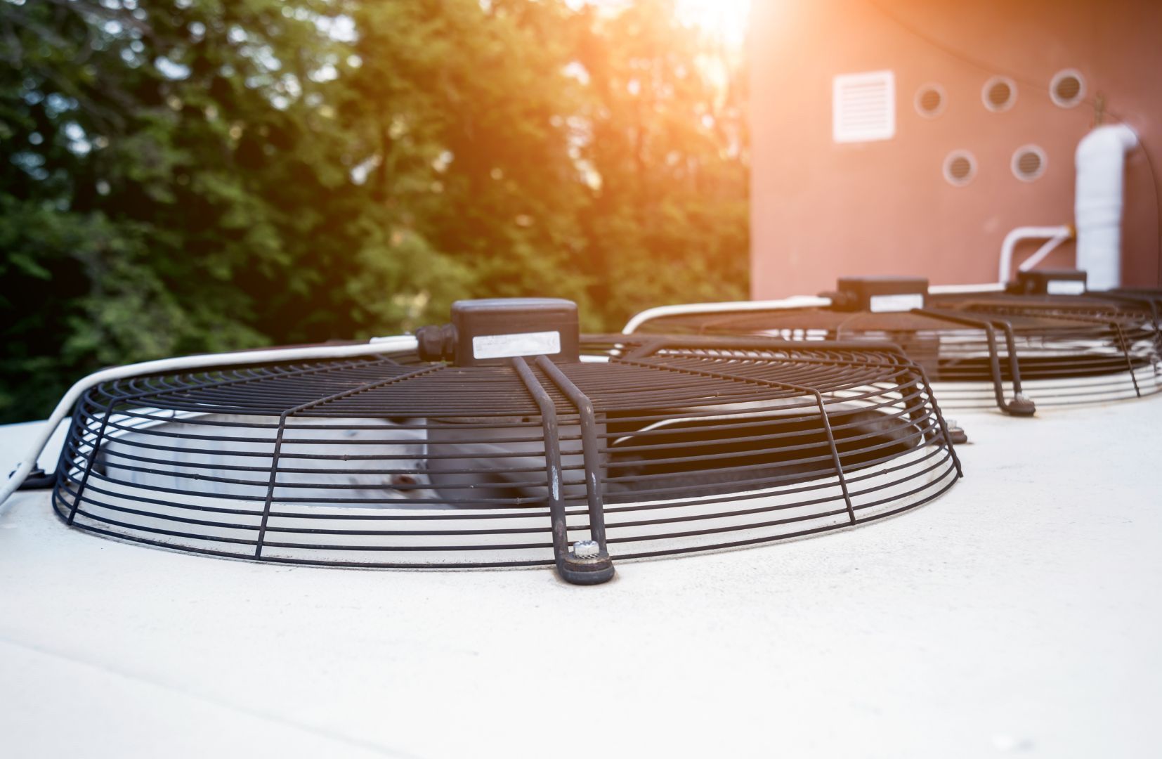 There are two fans on the roof of a building.