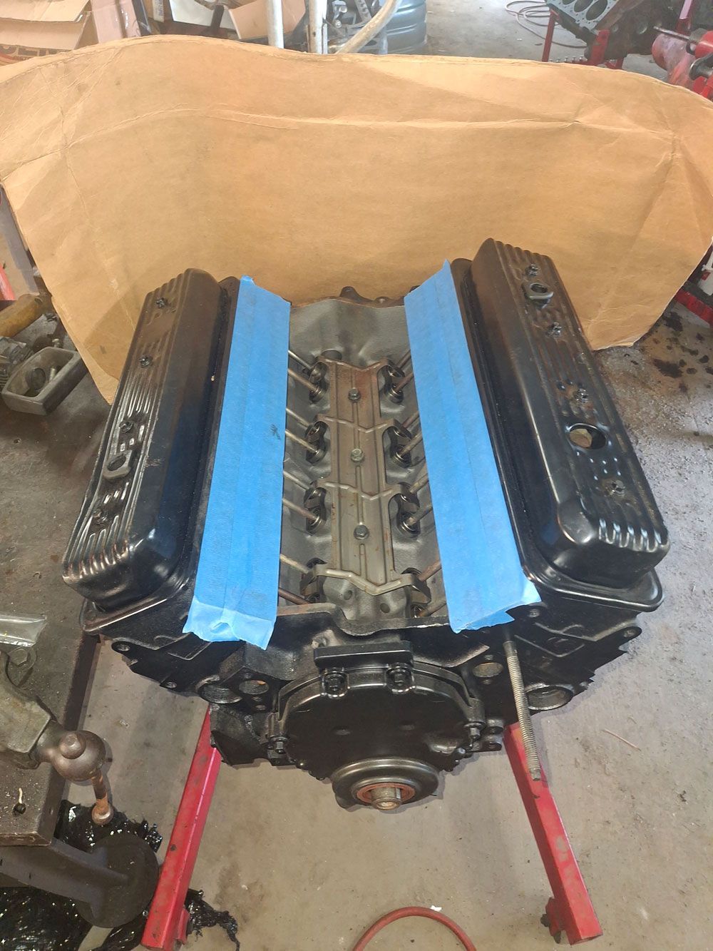 A bunch of gold pieces are sitting on a wooden pallet