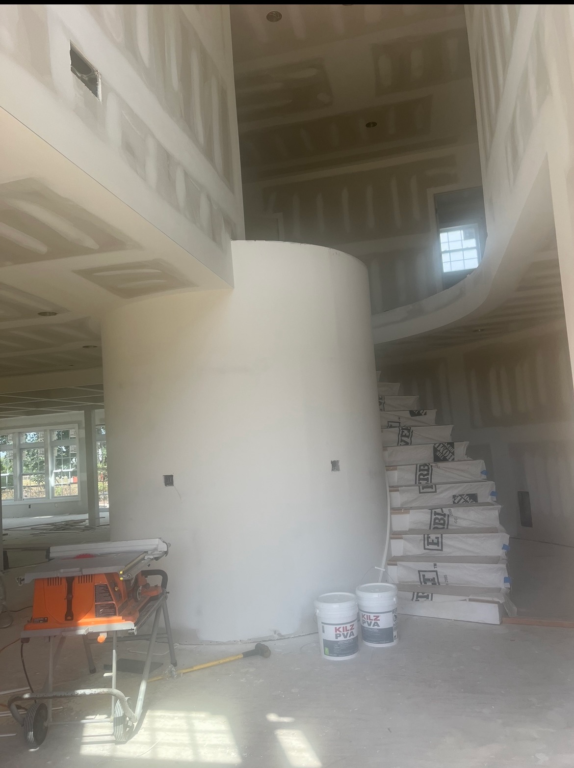 A large room with a spiral staircase in the middle of it.