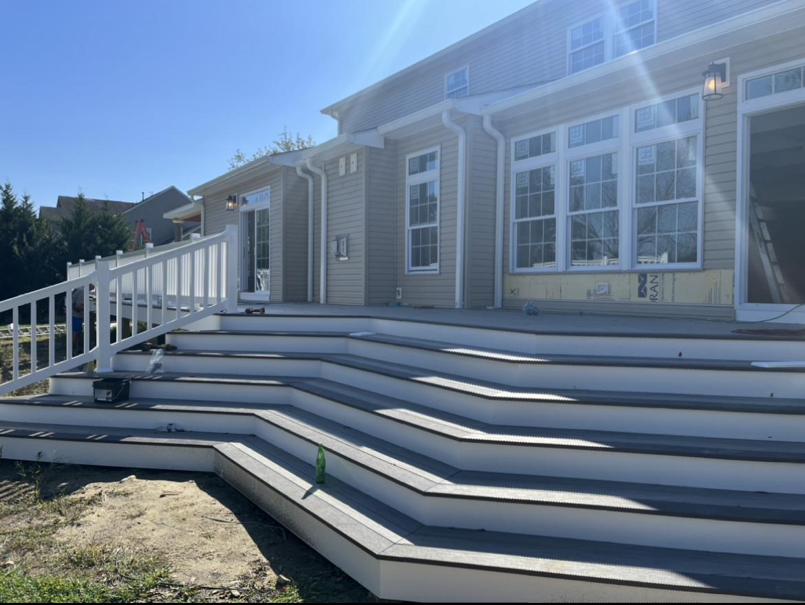 A large house with stairs leading up to it