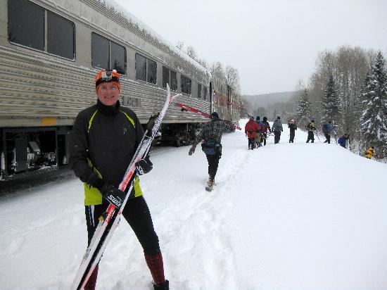 Skiers walking off train and preparing to start an adventure
