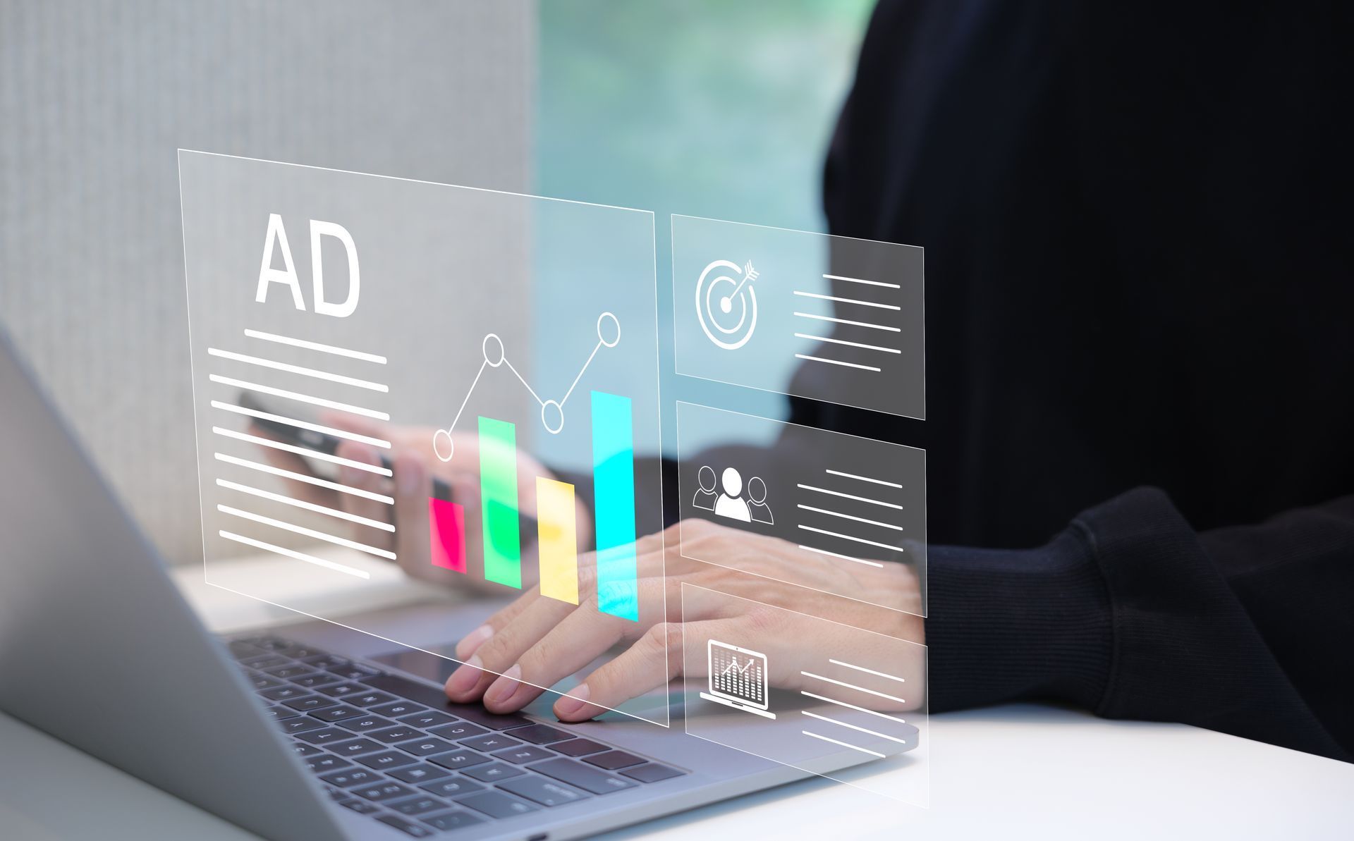 Person working on laptop with digital advertising data overlay.